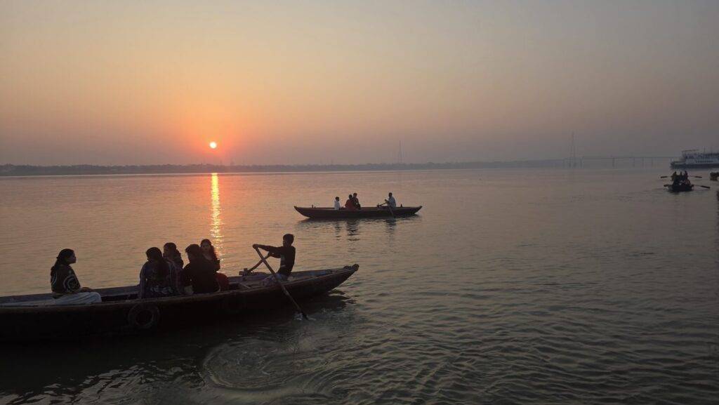 Rowing boats with passengers on the Ganga at sunrise near Assi Ghat